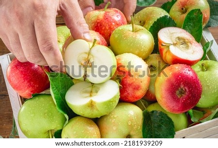 Wooden box with full of different red and green apples close up