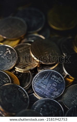 Macro shot of a large quantity of  Thai baht coins;Saving ,glass jar, Saving money concept on white background. exchange investment as concept.