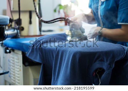 Image of laundry worker at work Royalty-Free Stock Photo #218195599