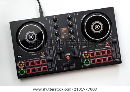 DJ Colorful mixing deck Controller connecting to Laptop and tablet using USB cable top view, isolated on white. Royalty-Free Stock Photo #2181977809