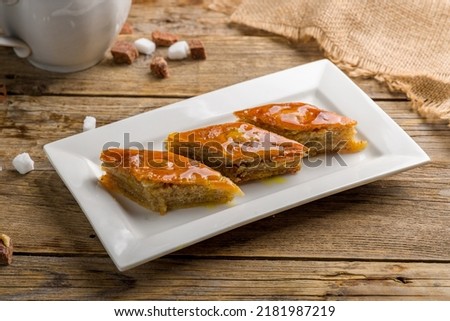 Baku baklava on white plate on old wooden table
