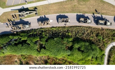 A high angle view directly above vintage tanks and military vehicles. It is a top down shot, taken on a sunny day with a drone on Long Island, New York. Royalty-Free Stock Photo #2181992725