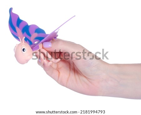 Kid toy butterfly in hand on white background isolation