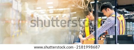 A man and women in charge of large warehouse checking the number items in warehouse that he is responsible for. checking goods in warehouse by scanning a barcode web banner with copy space on left
