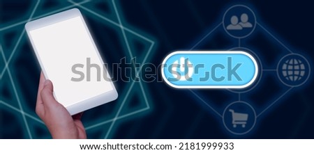 Businessman Holding A Tablet With Glowing Power Button Surrounded By Digital S. Man Holding A Touch Screen Device And Communicating Crucial Information And New Ideas.