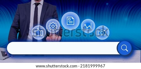 Businessman With A Laptop Pointing On Digital Synbols And Search Bar Looking For Data In An Abstract Design. Man In A Meeting And Checking Important Information And Concepts.