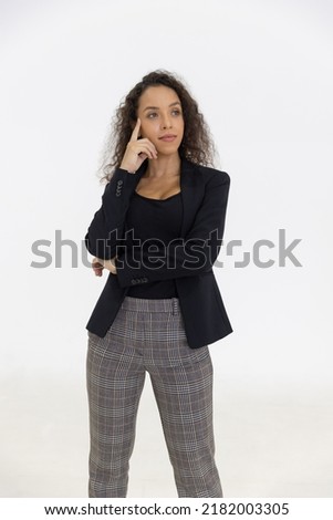 Portrait of smart caucasian businesswoman with curly hair in black jacket suite with trousers smiling arm crossed isolate on white background, vertical full body studio shot