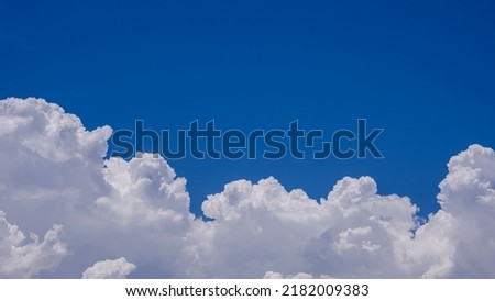 White Cumulonimbus Clouds on Blue Sky Background. Beautiful Summer sky in sunny day Royalty-Free Stock Photo #2182009383