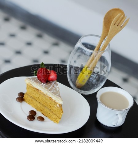 Tiramisu cake and a cup of chocolate milk on the table