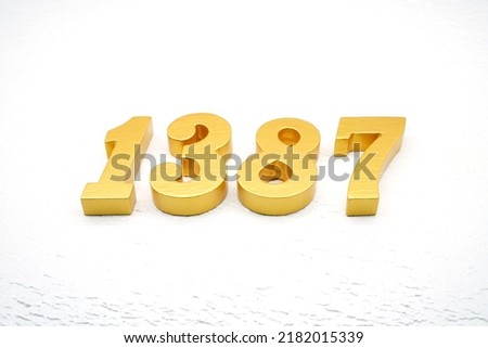   Number 1387 is made of gold painted teak, 1 cm thick, laid on a white painted aerated brick floor, visualized in 3D.                               