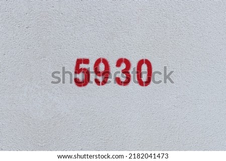 Red Number 5930 on the white wall. Spray paint.
