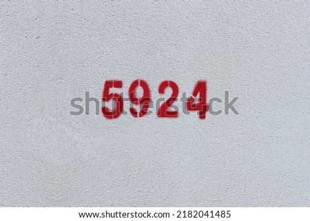 Red Number 5924 on the white wall. Spray paint.
