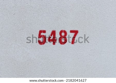 Red Number 5487 on the white wall. Spray paint.
