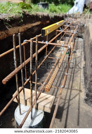 Reinforcement steel frame close up photo. Construction project in details. Reinforcement steel frame filled with cement. Strengthening the foundation of a building in process 