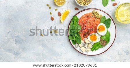 Keto diet food, salmon, avocado, cheese, egg, spinach and nuts. Ketogenic low carbs diet concept. Ingredients for healthy foods. Long banner format. top view. Royalty-Free Stock Photo #2182079631