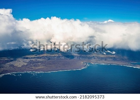 Beautiful scenery of landscape and Atlantic ocean. Aerial view of cloudscape covering mountains on seaside. Idyllic view of land and sea in northern Alpine region against blue sky.