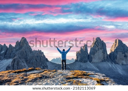 Tourist in blue jacket at Three Peaks of Lavaredo track on autumn season. National Park Tre Cime di Lavaredo, Dolomite Alps mountains, Trentino Alto Adige region, Sudtirol, Dolomites, Italy Royalty-Free Stock Photo #2182113069