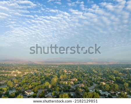 misty summer morning over Fort Collins and foothills of Rocky Mountains in northern Colorado, aerial view after heavy rainstorm with altocumulus clouds Royalty-Free Stock Photo #2182129851
