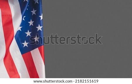Close-up of the American flag on a gray background. Space for text. Close-up photo