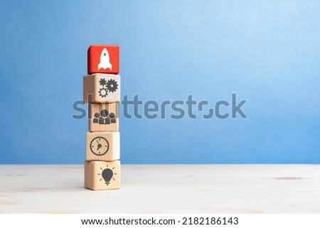 Business process management, Wooden cubes with business strategy and rocket icon, copy space Royalty-Free Stock Photo #2182186143