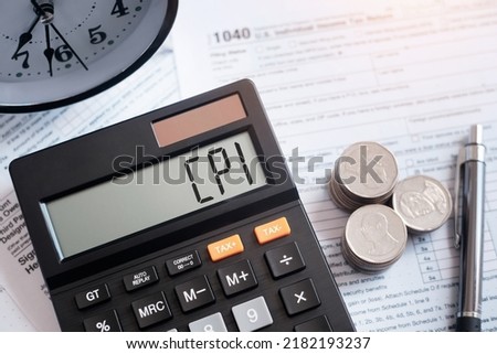 Business and CPI, consumer price index concept. Text CPI - Consumer Price Index.The word cpi on the calculator with coins, pen. Royalty-Free Stock Photo #2182193237