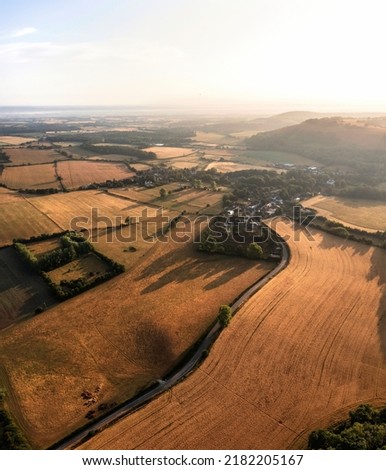 Stunning aerial drone panorama landscape image of South Downs in English countryside on Summer morning