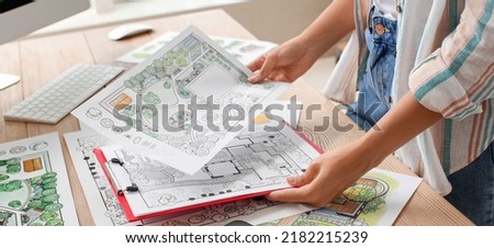Young female landscape designer working in office, closeup Royalty-Free Stock Photo #2182215239