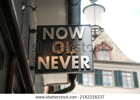 Selective focus picture of now or never sign at shop