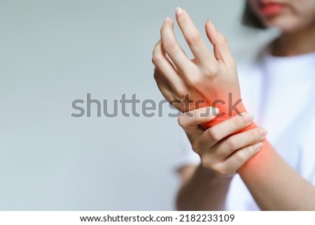 A woman has pain in her wrist. Health care concept. Royalty-Free Stock Photo #2182233109