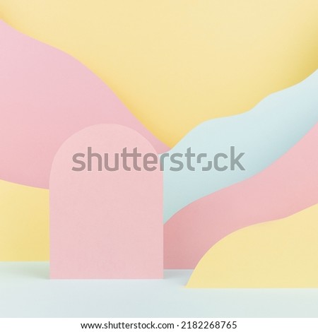Arch pink podium mockup with abstract mountain landscape - pastel pink, yellow, mint color slopes in baby cartoon naive style, square. Template for presentation of cosmetic, advertising, showing. 