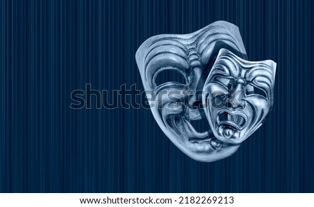 Comedy and Tragedy theatrical venetian mask with blue theater curtain