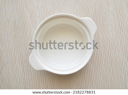 empty porcelain lunch box with decorative background Royalty-Free Stock Photo #2182278831