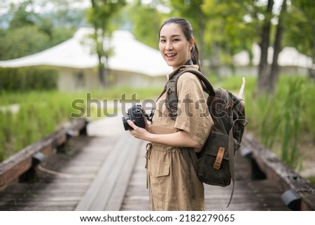 Asian girl backpack in nature the mountains of Khao Yai , Relax time on holiday concept travel,Photographer Travel Sightseeing Wander Hobby Recreation Concept