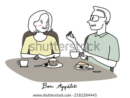 Happy senior woman drinking tea or coffee with husband in a coffee shop. Mature couple enjoying eating desserts together. Relationship concept with senior couple talking and smiling together at café.