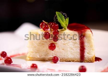 fresh New York cheesecake on a white plate with berries . serving dessert in a food restaurant photo.