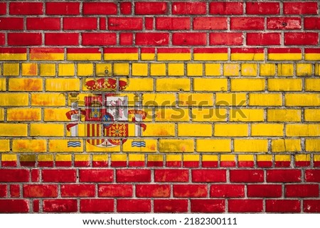 National  flag of the Spain  on a grunge brick background.
