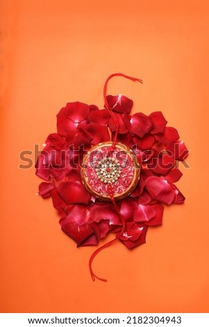 Raksha bandhan rakhi with flower and kumkum Royalty-Free Stock Photo #2182304943