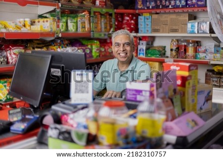  Happy man working as a cashier at supermarket