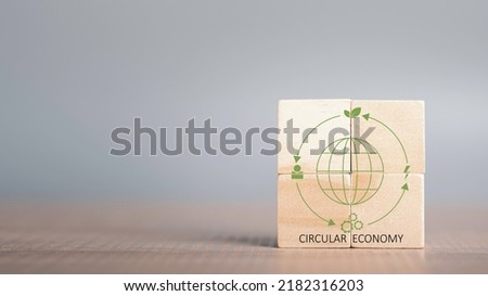 Circular economy cycle concept, sustainable recycle energy, environment, reuse, manufacturing, consumer, resources. LCA Life cycle assessment.Wooden cubes of circular economy on grey background.