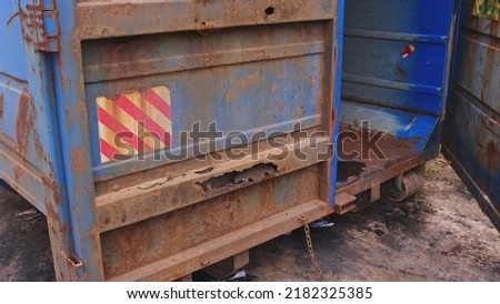 Large Blue Industrial Steel Construction Site Garbage Container with Rusty Doors Royalty-Free Stock Photo #2182325385