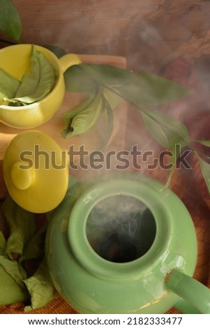 Coffee and tea set with cherries and pastries in green and yellow, product picture