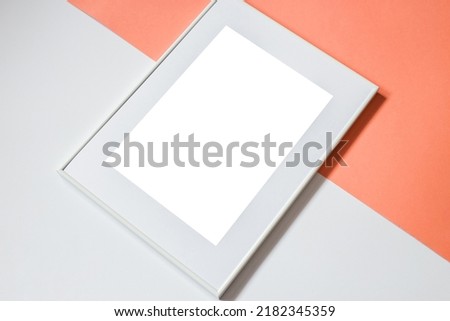 White picture frame with decorations. Mock up for your photo or text. Place your work, print art, white background, pastel color book. Photo realistic 3d illustration. Orange and white background