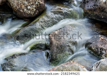 Water flowing around rocks in Wicklow, Ireland