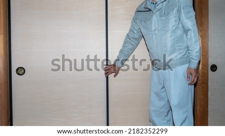 A worker who inspects the sliding doors. "Japanese fusuma" Royalty-Free Stock Photo #2182352299