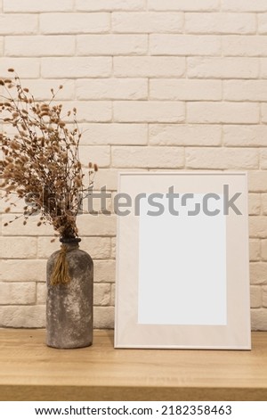 White picture frame with decorations. Mock up for your photo or text. Place your work, print art, white background, pastel color book. Photo realistic 3d illustration, home decor, home wall
