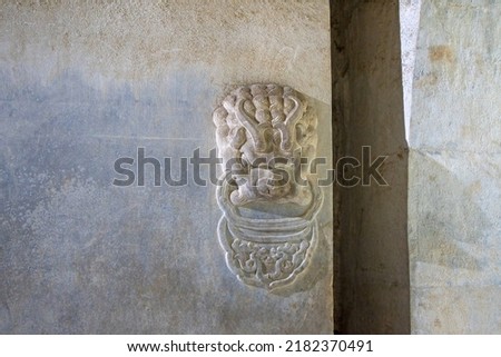 The stone lion carved in rock is on the tomb door of the emperor of the Qing Dynasty in China