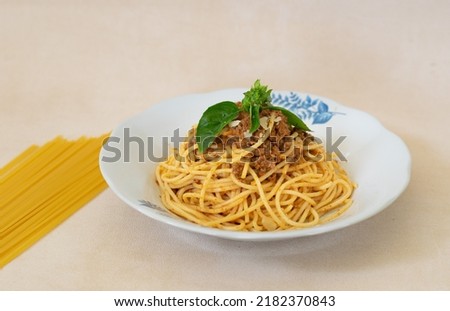 Spaghetti Bolognese with minced beef, onion, chopped tomato, garlic, olive oil, stock cube, tomato puree and Italian herb. Traditional Italian food in white plate

