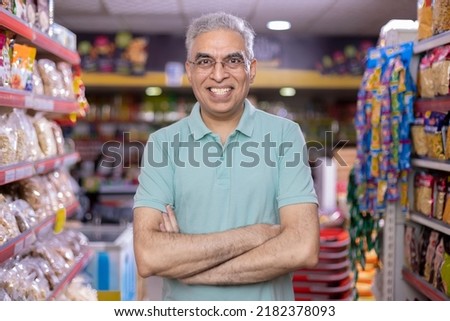 Senior man at supermarket store Royalty-Free Stock Photo #2182378093