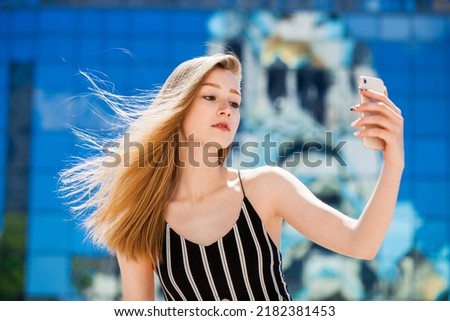 Selfie. Young beautiful blonde girl with mobile phone