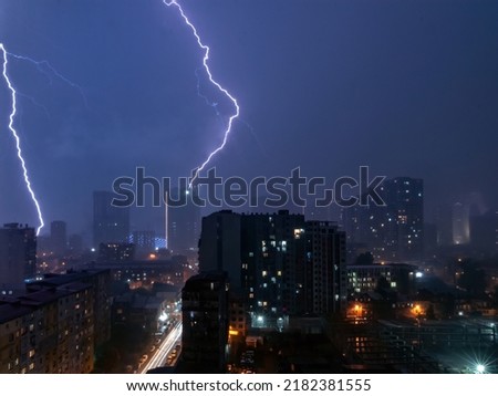 lightning strike thunderstorm weather over night city. long exposure scene